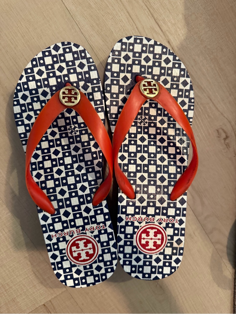 Tory Burch Navy Geometric Flip Flops with Orange Straps and Gold Emblems